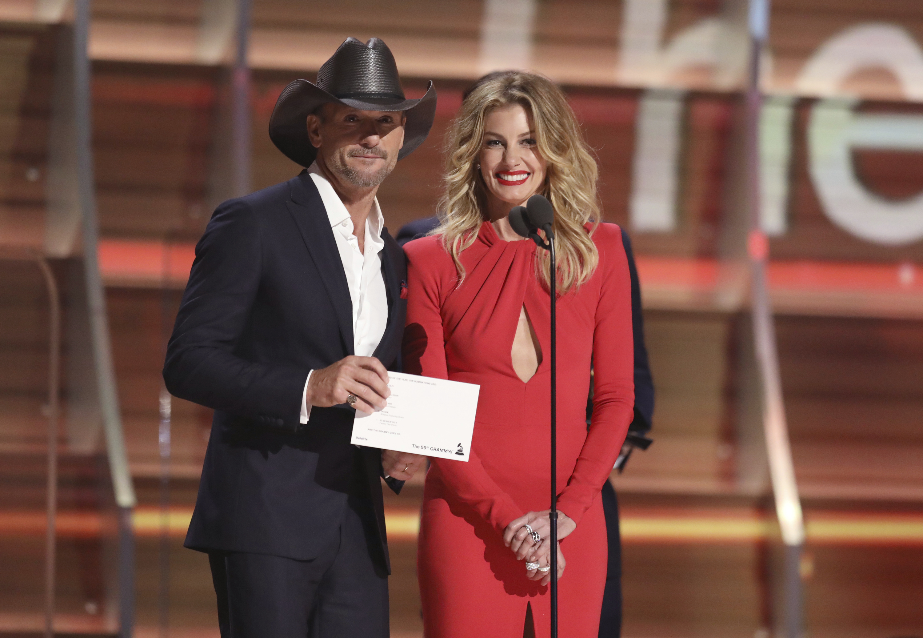 Tim McGraw, left, and Faith Hill present the award for record of the year at the 59th annual Grammy Awards in Los Angeles- AP